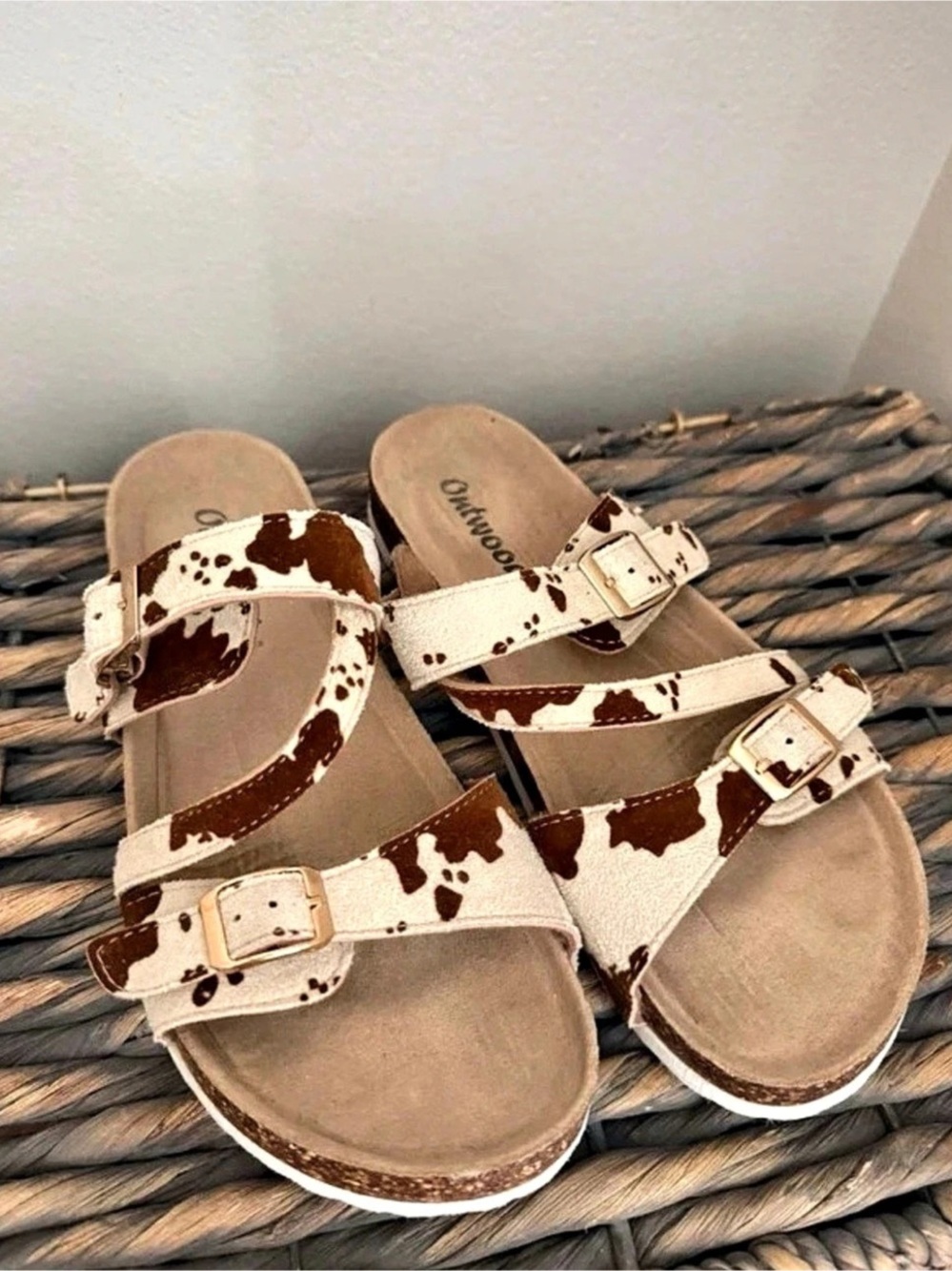 Oofos Cow Print Buckle Sandals in White & Brown